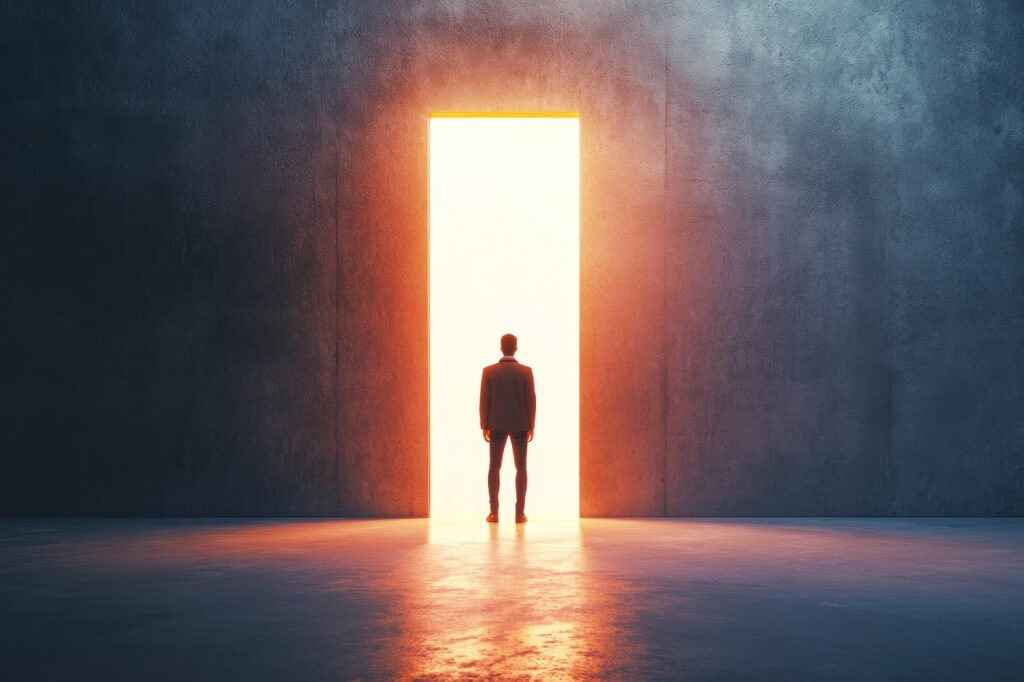 Man standing before open door