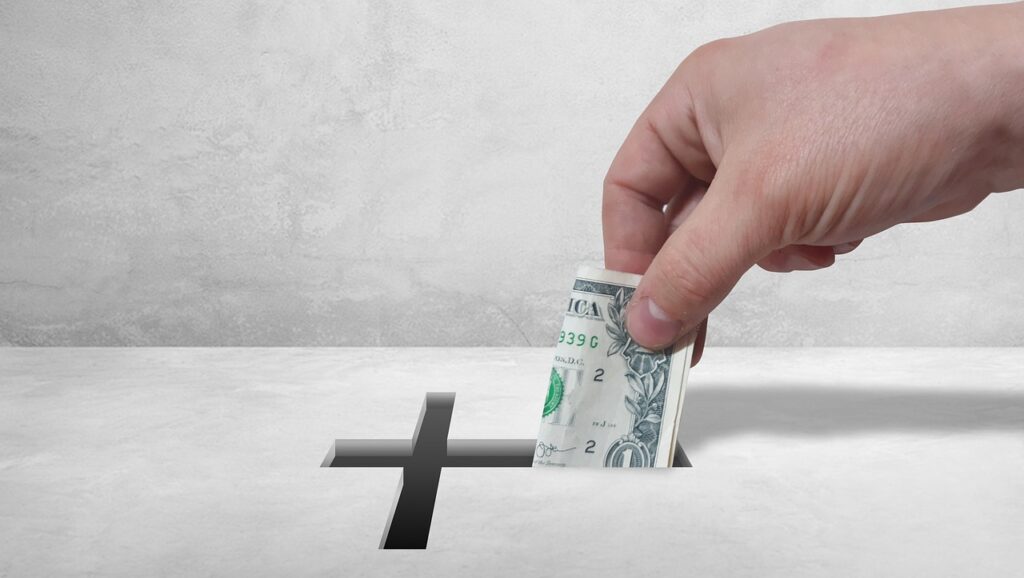 Man placing money in offering box at church