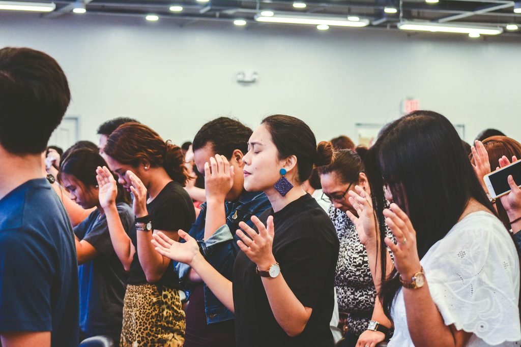 Group of christians raising hands in worship