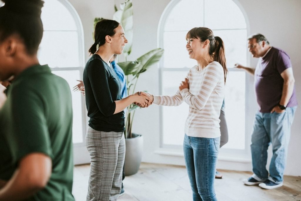 Young asian woman being welcomed to church